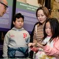 Children and researcher at museum