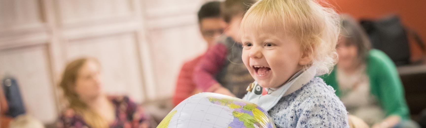 Child holding a globe