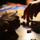 Two players move their pieces on a board game 