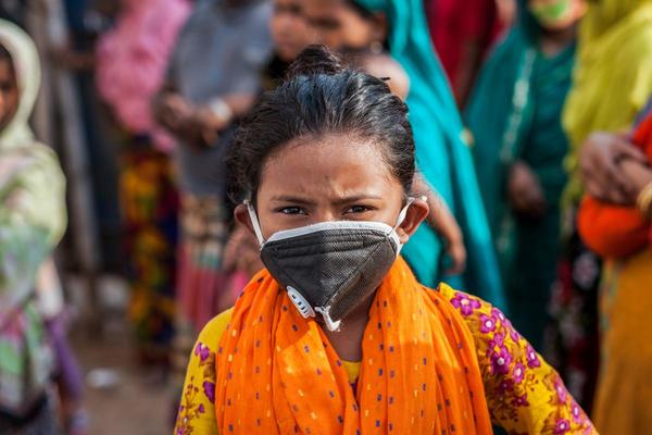 A young girl wearing a face mask