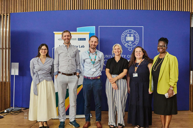 Six representatives of the Local Policy Lab partnership smile for the camera