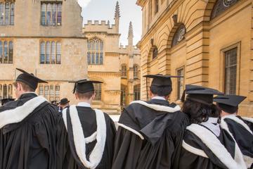 Students wearing gowns and mortar boards outside the Sheldonian