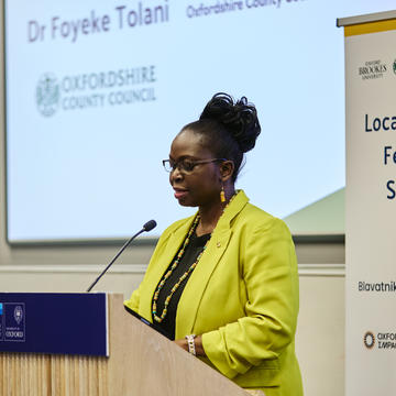Dr Foyeke Tolani addresses an audience from the lectern