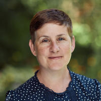 Professor Kathryn Eccles Professor Eccles has short brown hair. She is wearing a navy blouse with white spots.