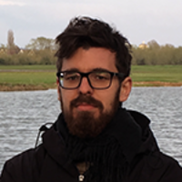 Dr Martin Michette is pictured with a river and green field in the background