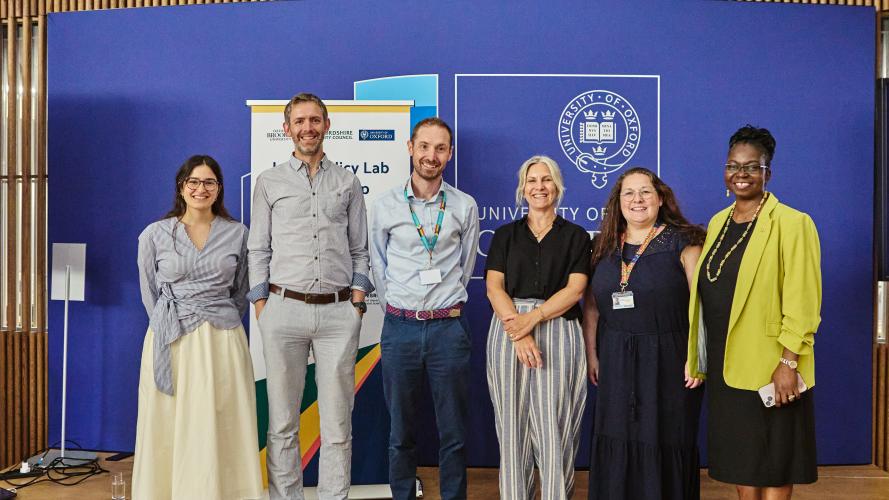 Six representatives of the Local Policy Lab partnership smile for the camera
