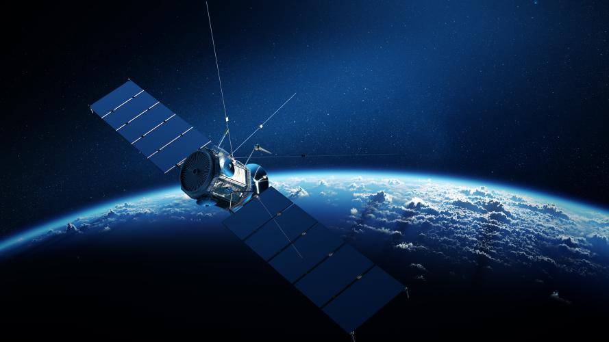 Communications satellite orbiting Earth with sunrise in space