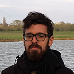 Dr Martin Michette is pictured with a river and green field in the background
