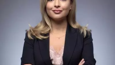 Tamta has light coloured long hair and is smiling into the camera