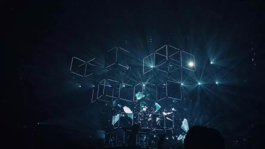 A series of light boxes are illuminated in a dark room