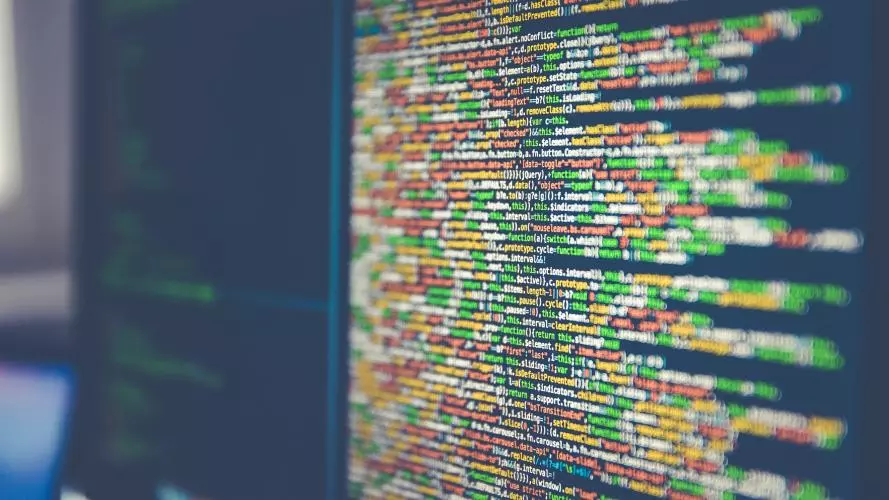 Pages of mmulti-coloured code across two computer screens