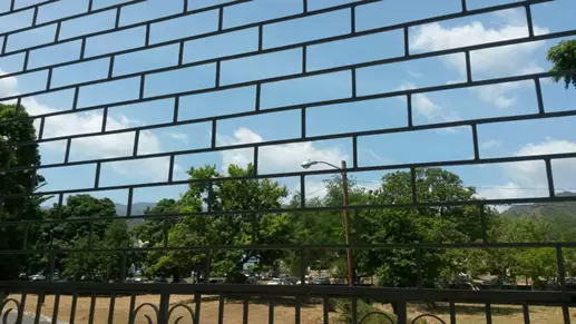Image of a detention centre with bars across the whole image