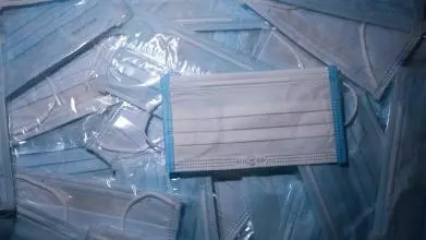 A pile of blue, medical grade face masks