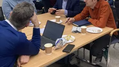 common ground seminar series  ai and society 13112023 researchers and academics sat around a table in discussion