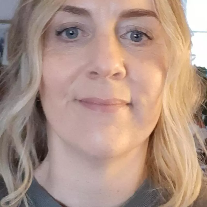 Tessa has long blonde hair and is smiling at the camera
