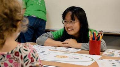 A DPhil researchers interacts with a young girl