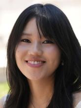 East Asian woman with long black hair and white dress