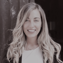 Francesca mazzi stands against a dark background