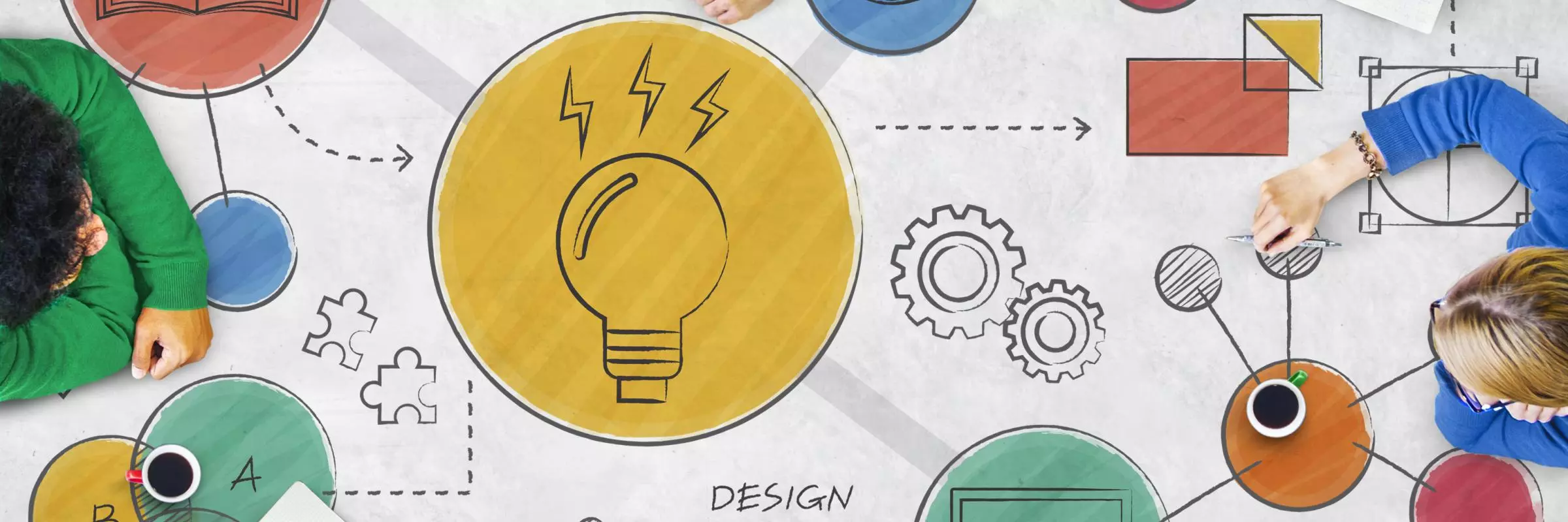 Eight people of diverse ethnicities sit around a table sketching out colour ideas in graphic form, including a book, lightbulb, eye, arrow, jigsaw puzzle piece, and cog.
